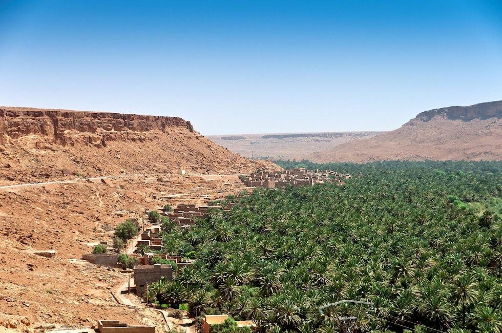 Aerial view of the lush palm grove in Ziz Valley near Errachidia, Morocco, surrounded by desert cliffs