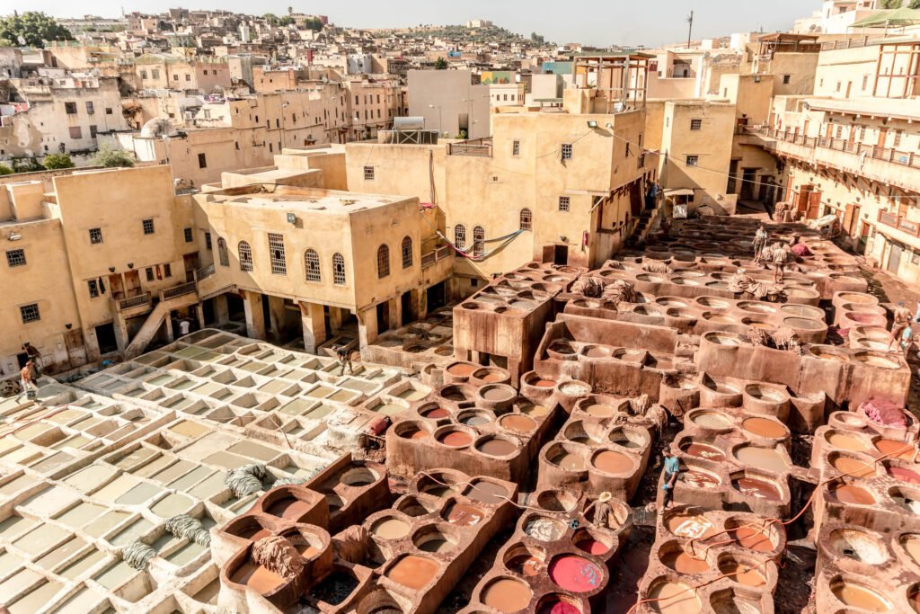 View over Chouara Tannery in Fes, Morocco showing dozens of traditional stone vats used for dyeing leather