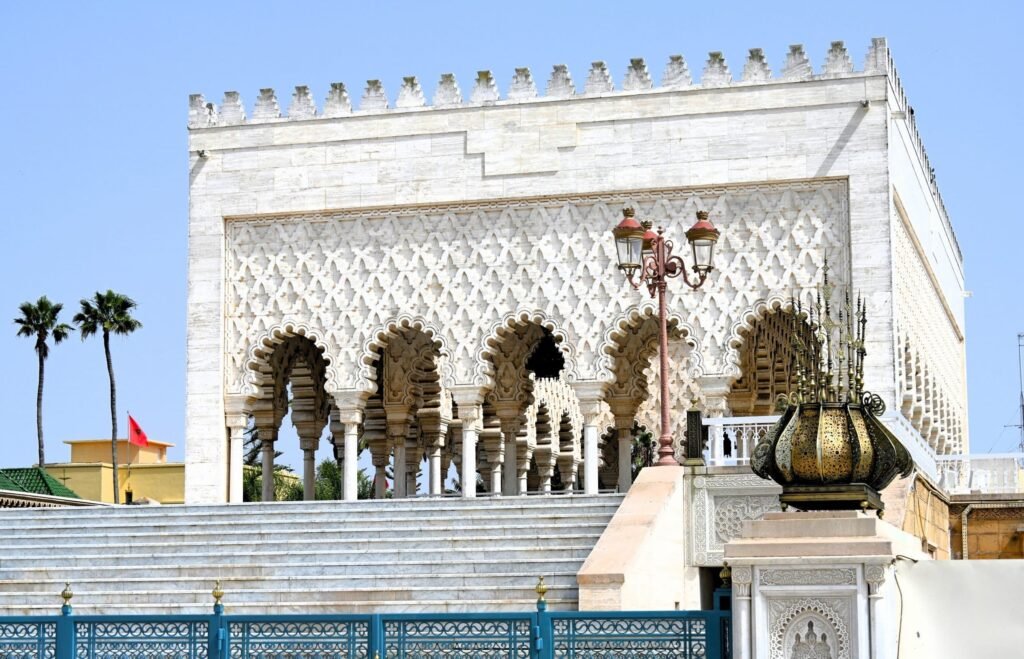 Mausoleum of Mohammed V in Rabat, Morocco with white marble walls and traditional arches under a clear blue sky