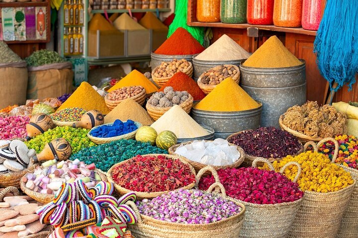Colorful Moroccan spice pyramids on display in a traditional souk